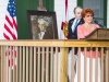 Docent, Diane Wisen accepting a portrait of George Washington from Charles Dauray.