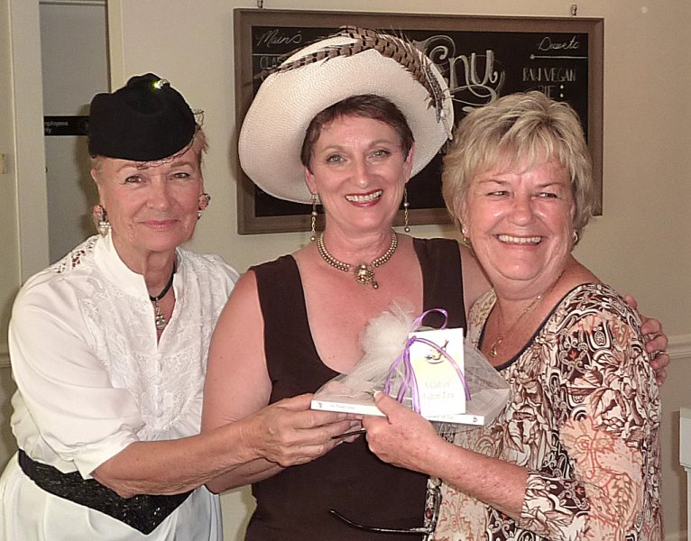 Carolyn and Pam present the door prize to Judy